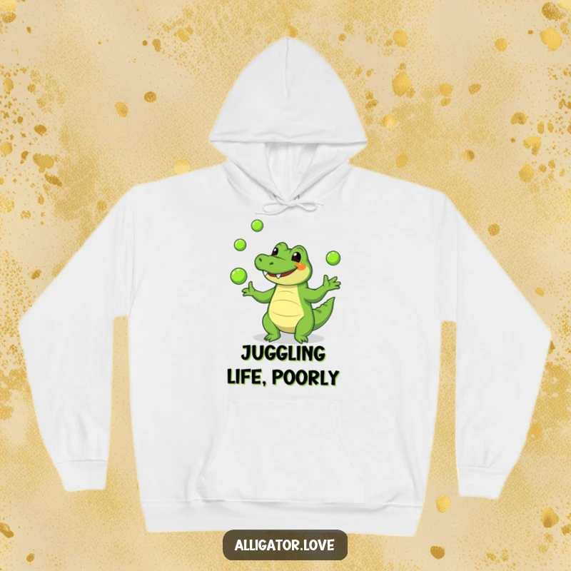 Funny alligator hoodie showcasing a cheerful reptile masterfully juggling green balls, offering warmth and humor.